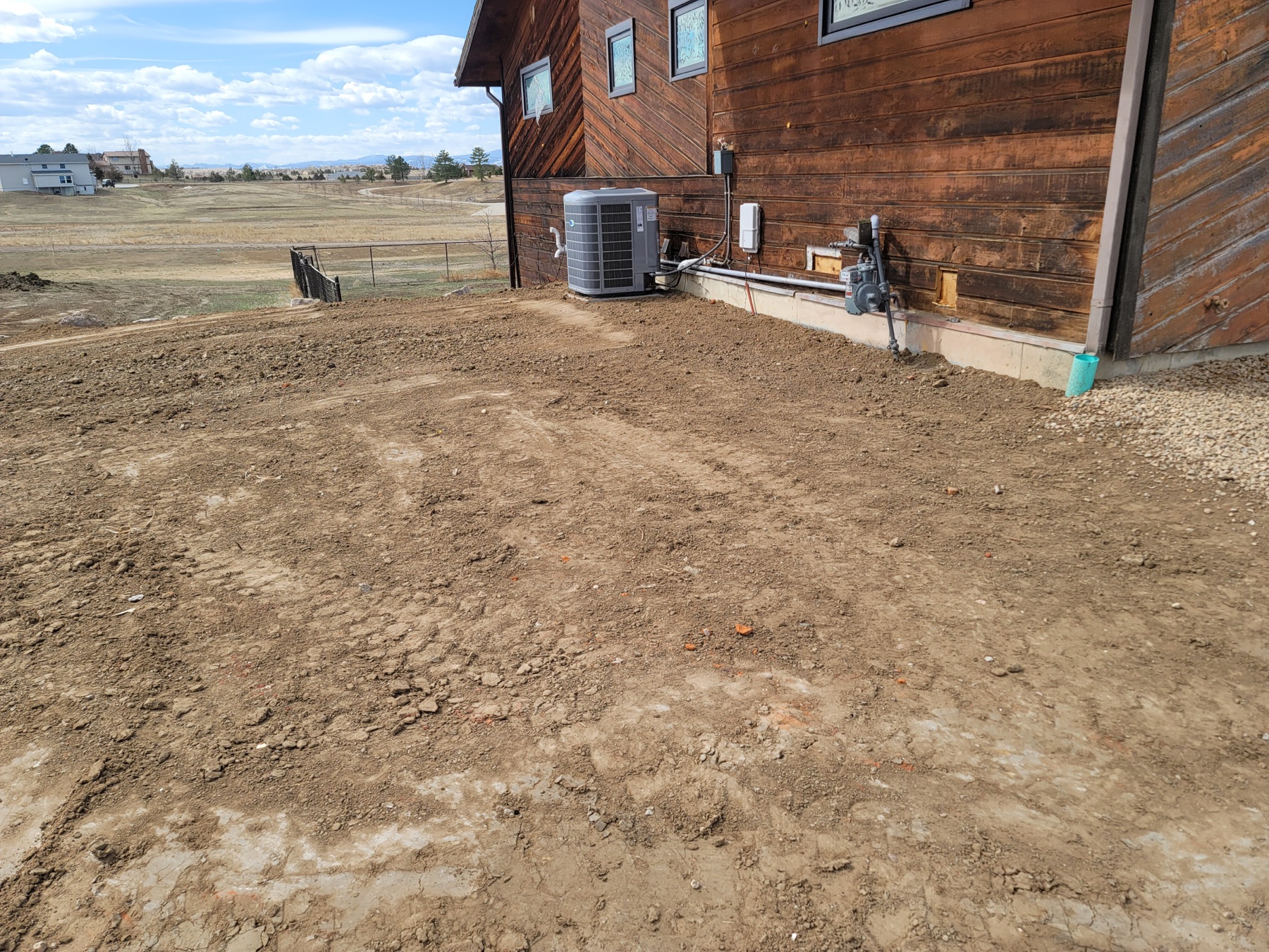 Fresh trench with drainage pipe across an open property