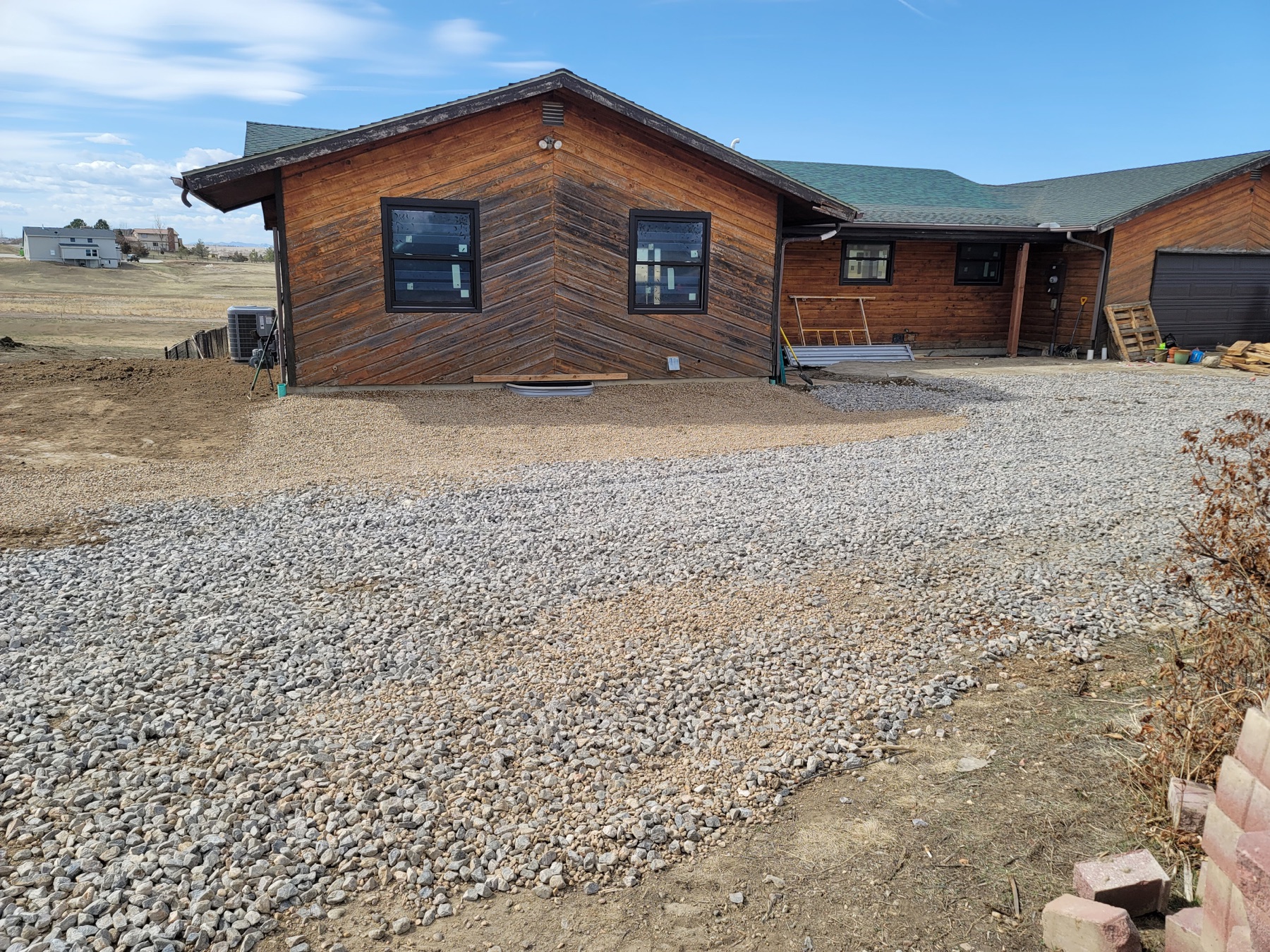 Completed gravel driveway around a mountain-area home
